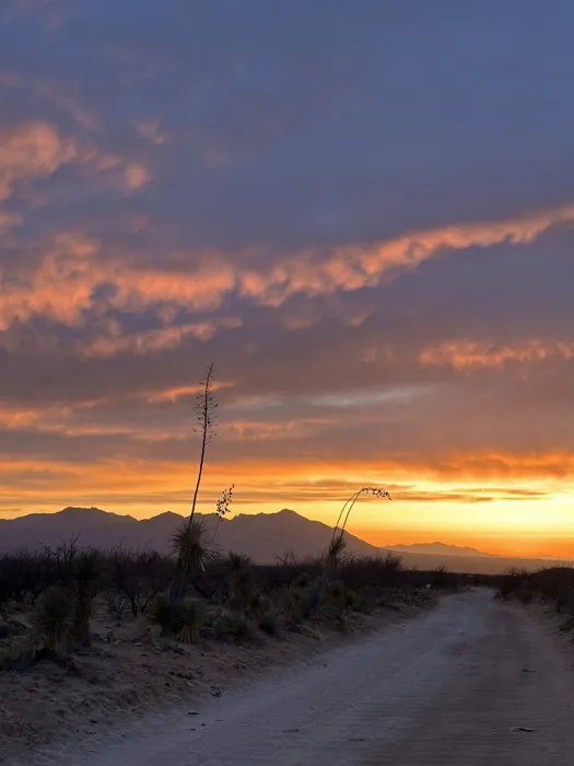 Desert sunset over the road leading to the retreat site