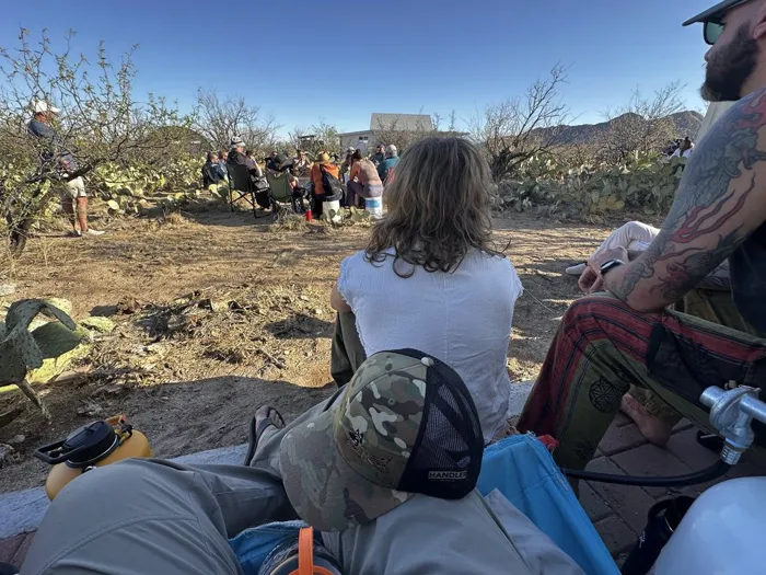 Veterans seated among desert cactus during an outdoor group session